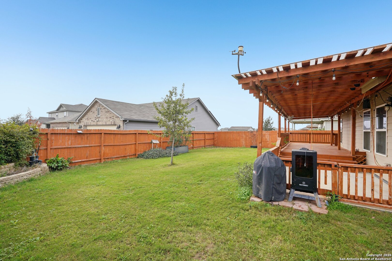 13030 Heathers Reef St. Hedwig, TX 78152 - Photo 40 of 51 a view of a backyard with wooden fence