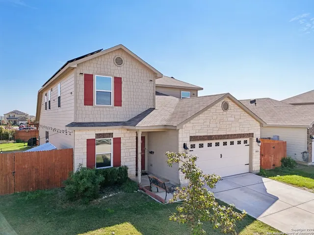 a aerial view of a house next to a yard