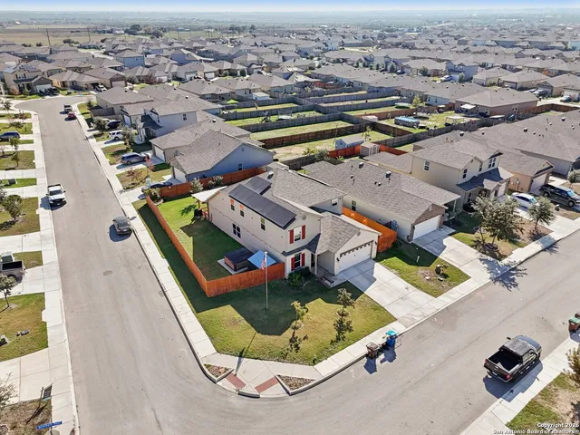 an aerial view of residential houses with outdoor space