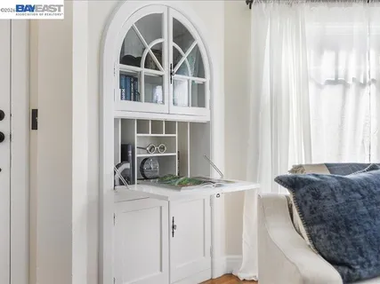 a living room with a bed and a large window