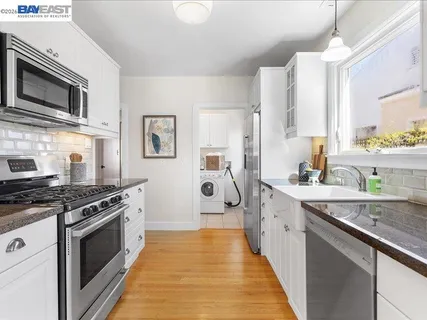 a kitchen with stainless steel appliances a stove sink and cabinets