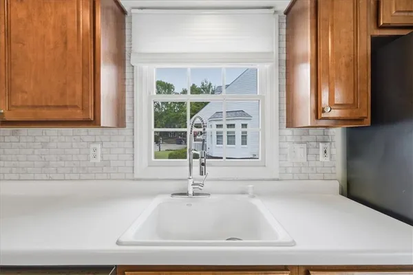 a bathroom with mirror and window