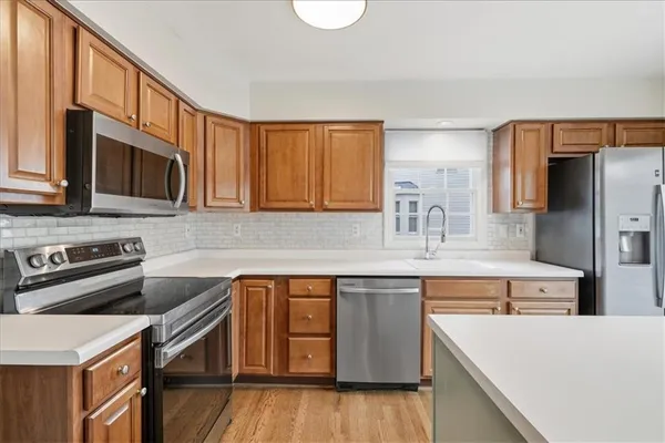 a kitchen with stainless steel appliances granite countertop a sink stove and refrigerator