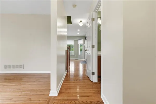 a view of a hallway with wooden floor