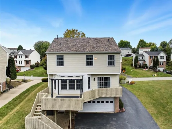 an aerial view of a house with a yard