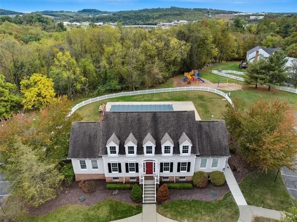 an aerial view of multiple houses with yard