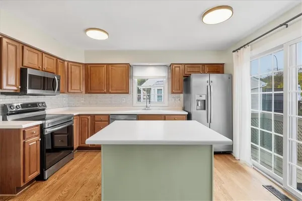 a kitchen with refrigerator and cabinets