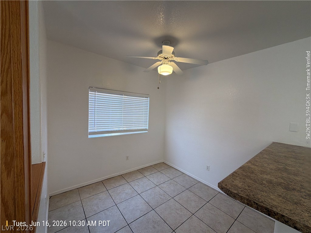 4730 East Craig Road, Unit 1124 Las Vegas, NV 89115 - Photo 6 of 22 A well-lit, compact interior space features durable tile flooring and a ceiling fan for comfort.