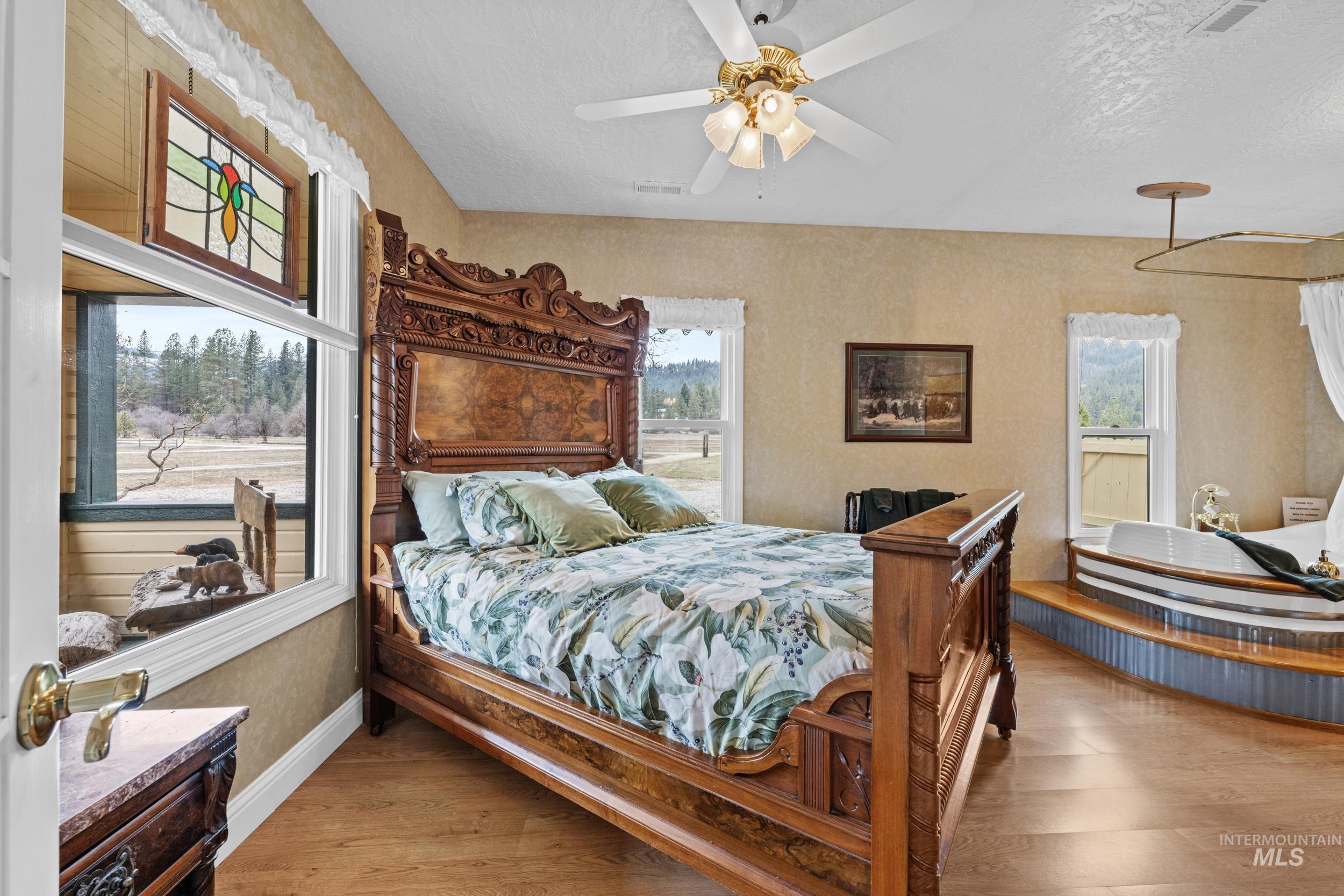 69 River Ranch Road Garden Valley, ID 83622 - Photo 18 of 50 Bedroom with light wood-style floors, a textured ceiling, and ceiling fan