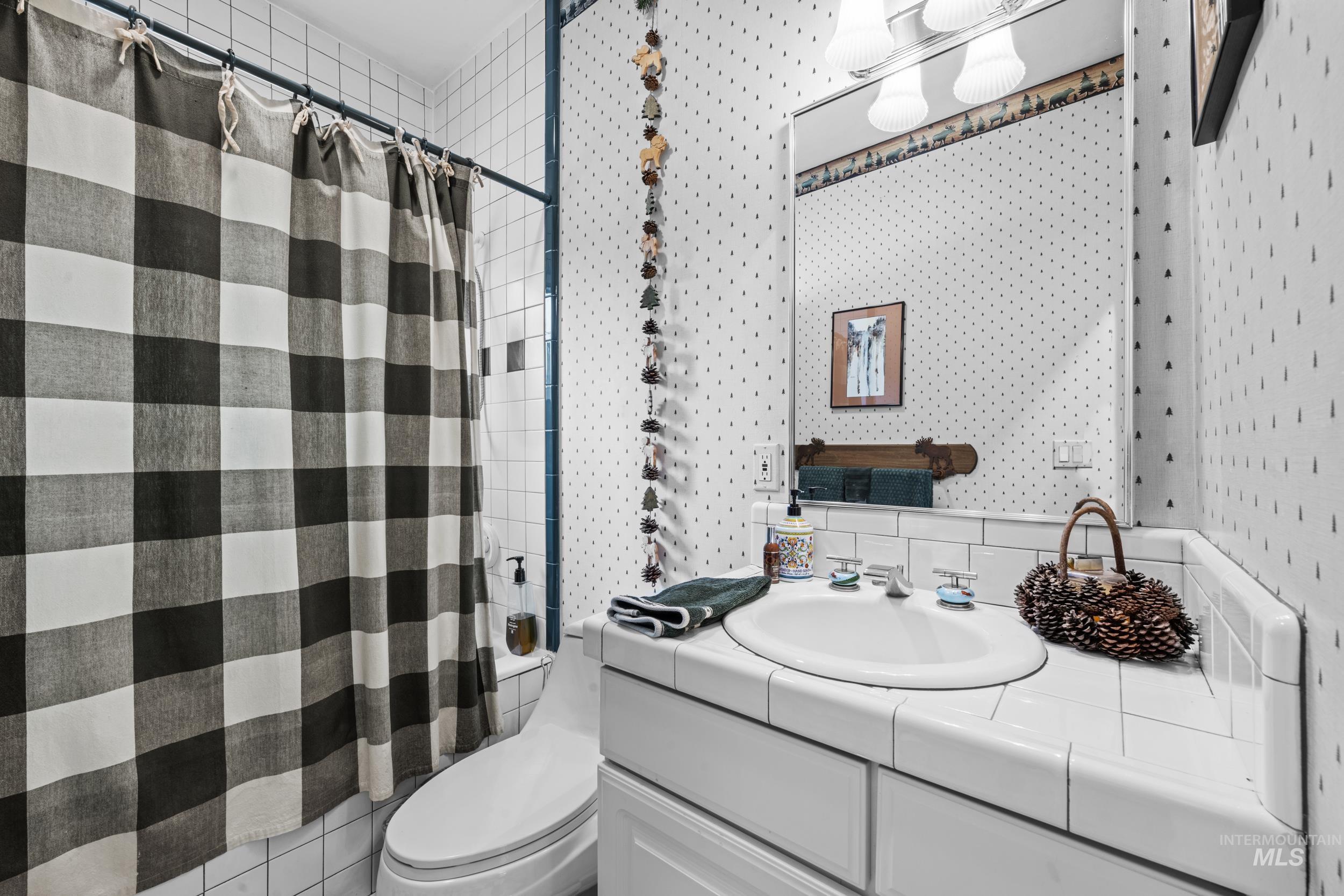 69 River Ranch Road Garden Valley, ID 83622 - Photo 22 of 50 Full bathroom featuring vanity and tasteful backsplash