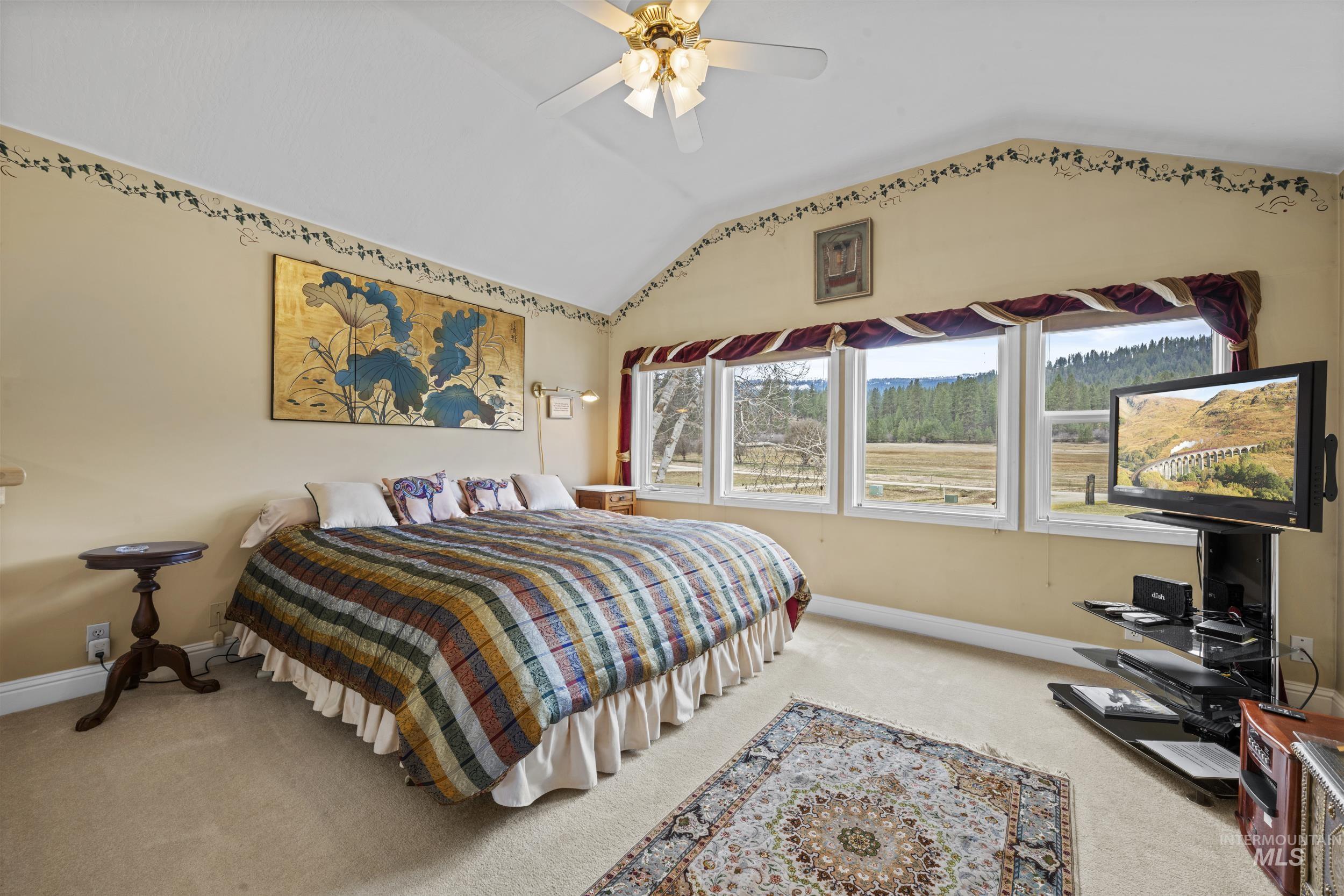 69 River Ranch Road Garden Valley, ID 83622 - Photo 29 of 50 Bedroom with light carpet, vaulted ceiling, and a ceiling fan
