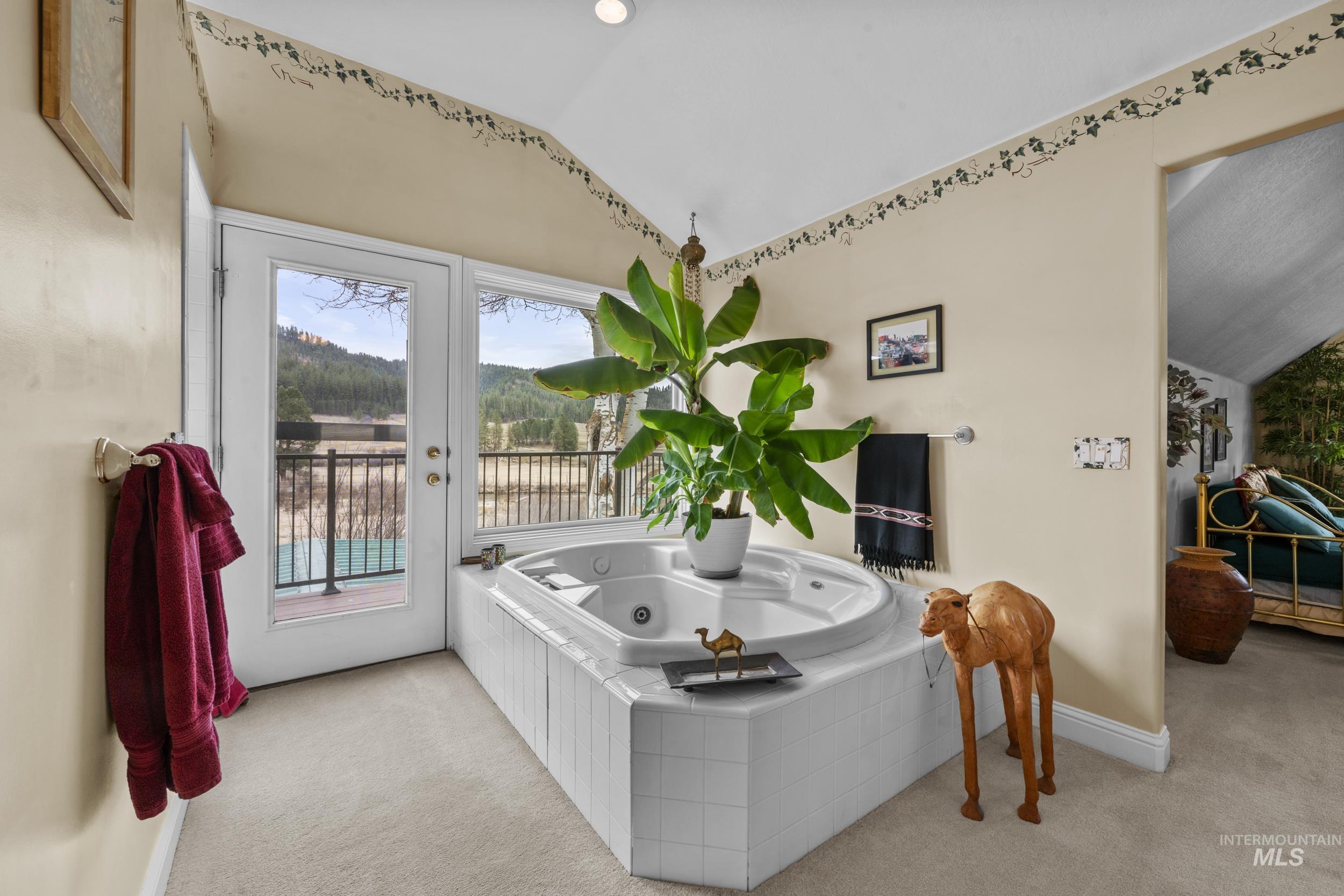 69 River Ranch Road Garden Valley, ID 83622 - Photo 31 of 50 Bathroom with lofted ceiling, light carpet, and a tub with jets