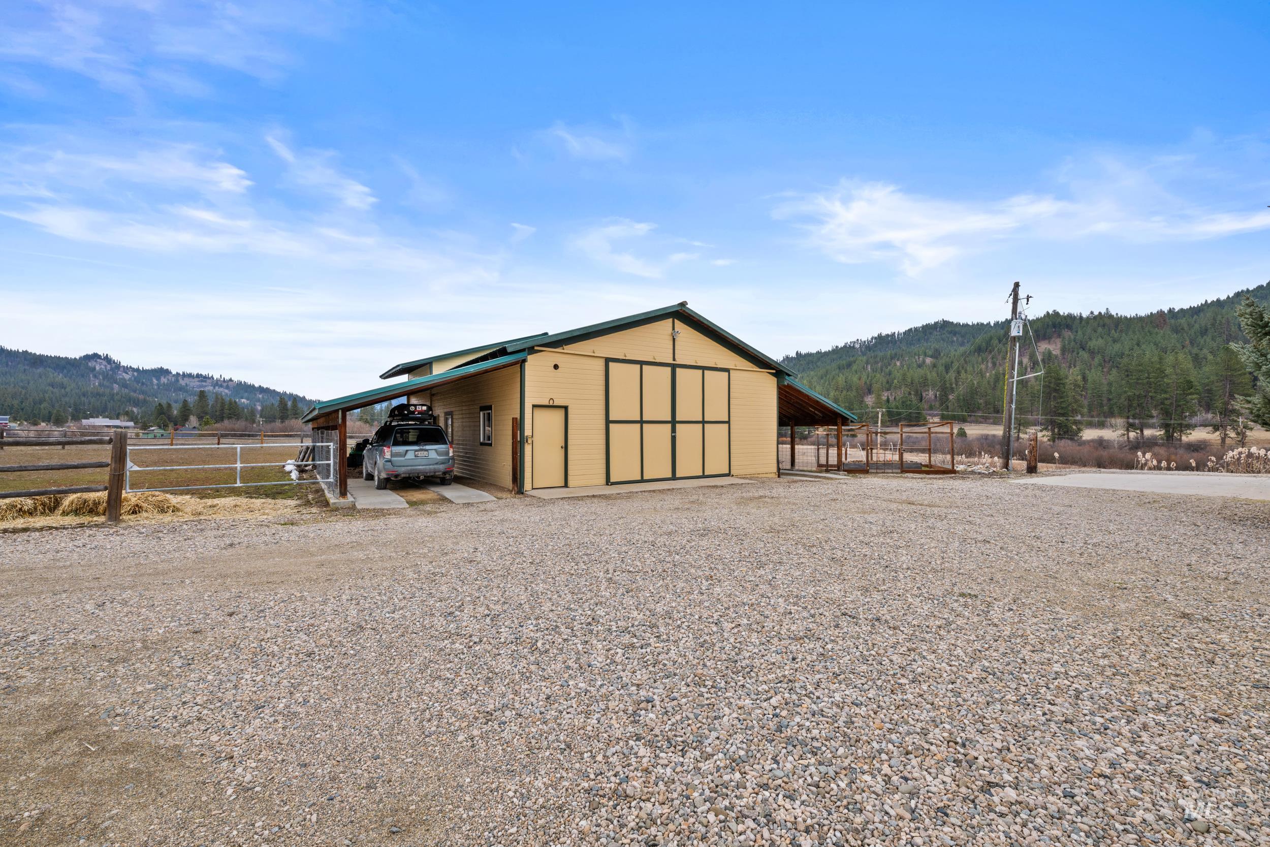 69 River Ranch Road Garden Valley, ID 83622 - Photo 37 of 50 View of outdoor structure featuring a mountain view and gravel driveway