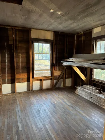 a view of a livingroom with wooden floor and window