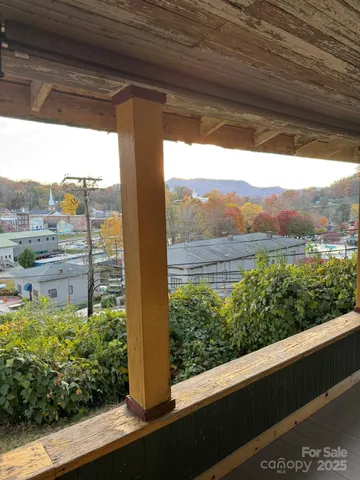 a view of a lot of trees and a couple of cars parked on street