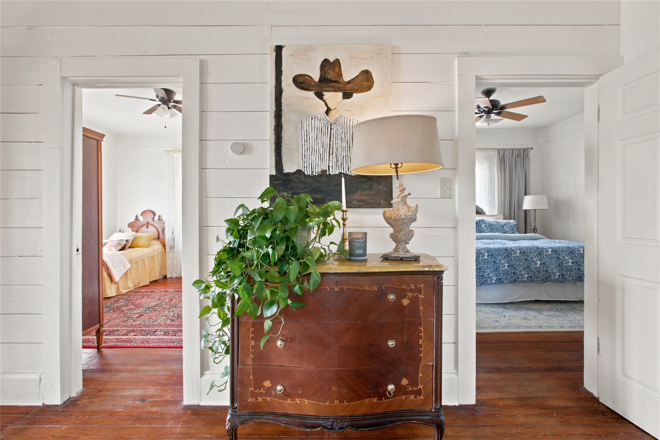 372 Old Lockhart Road Lockhart, TX 78644 - Photo 28 of 40 Hardwood floors guide you into bedrooms with ceiling fans, ensuring comfort and style.