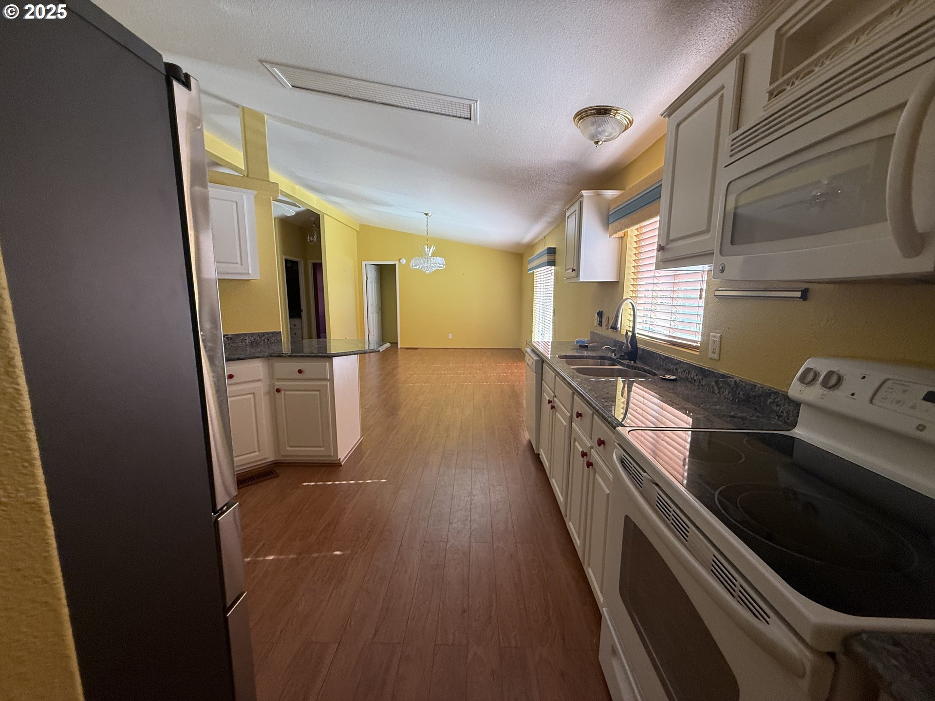Undisclosed Address Canyonville, OR 97417 - Photo 21 of 24 a kitchen with granite countertop a sink a counter top space stainless steel appliances and cabinets