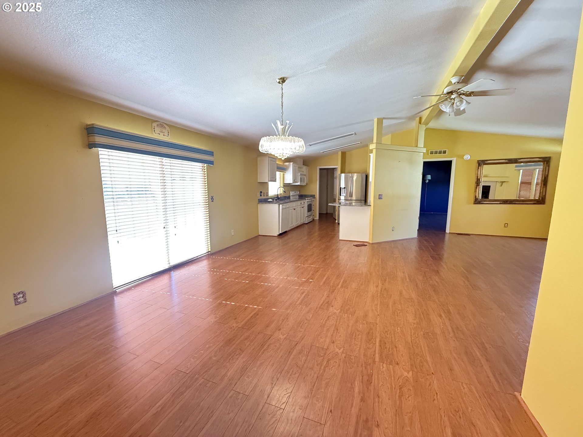 Undisclosed Address Canyonville, OR 97417 - Photo 22 of 24 a view of a big room with wooden floor and chandelier