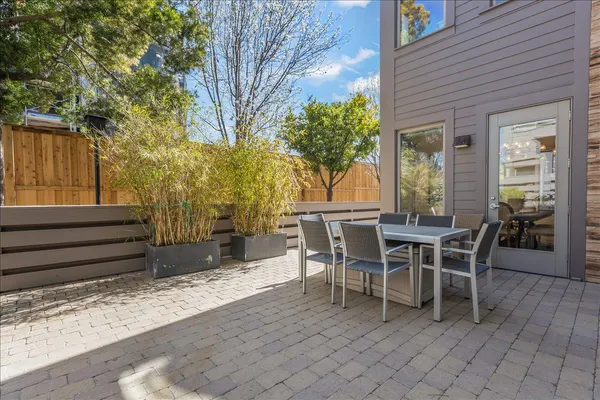 a view of a patio with table and chairs and wooden floor