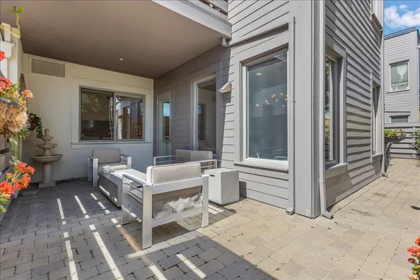 a building outdoor space with patio furniture and potted plants