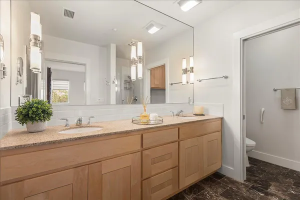 a bathroom with a double vanity sink and a mirror