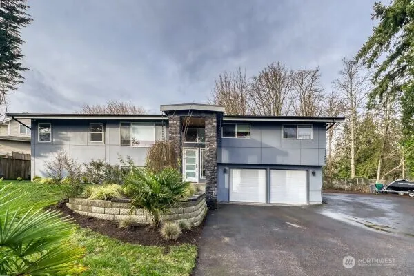 a front view of a house with a yard garage and outdoor seating