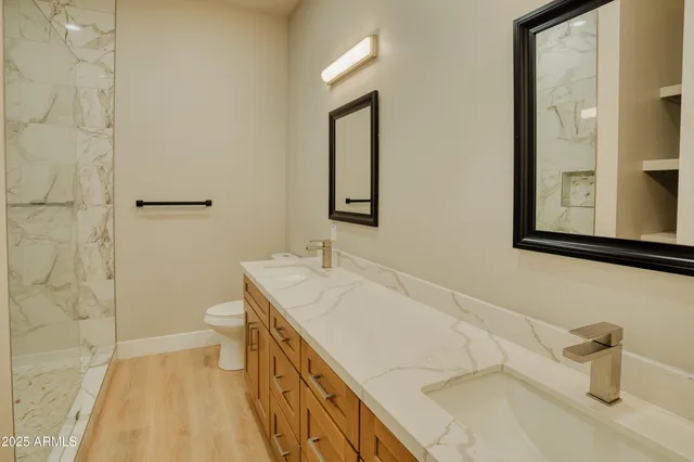 a bathroom with a sink a toilet and mirror