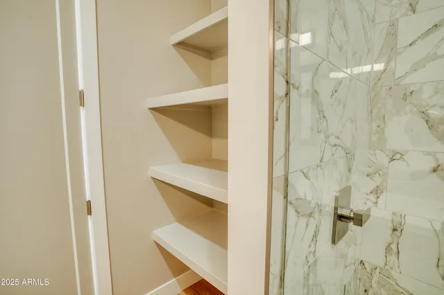 a bathroom with a shower and mirror