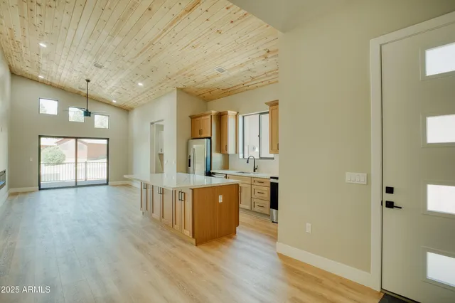 a large room with wooden floor and windows