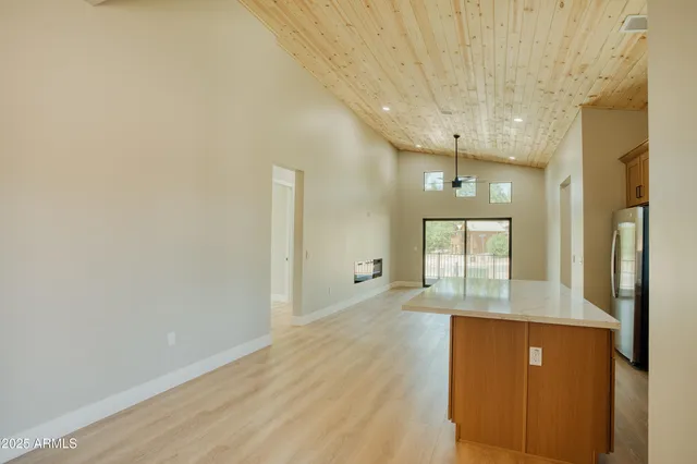 a kitchen with a stove a sink and a window