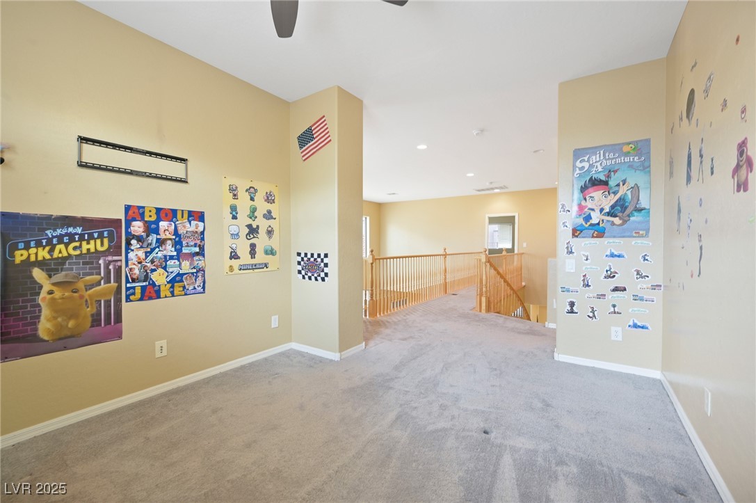 2289 Manosque Lane Henderson, NV 89044 - Photo 20 of 35 Carpeted spare room with baseboards and ceiling fan