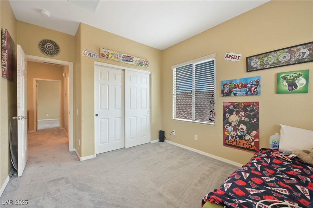 2289 Manosque Lane Henderson, NV 89044 - Photo 22 of 35 Bedroom with light carpet and a closet