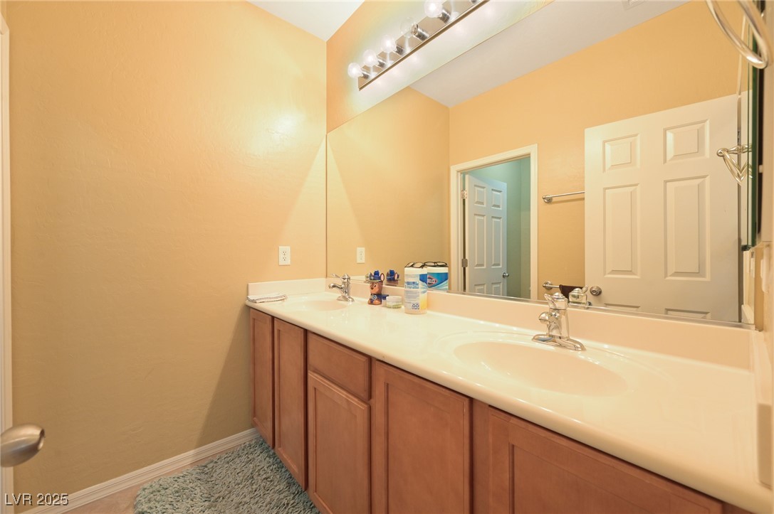 2289 Manosque Lane Henderson, NV 89044 - Photo 23 of 35 Full bath featuring double vanity and light tile patterned floors
