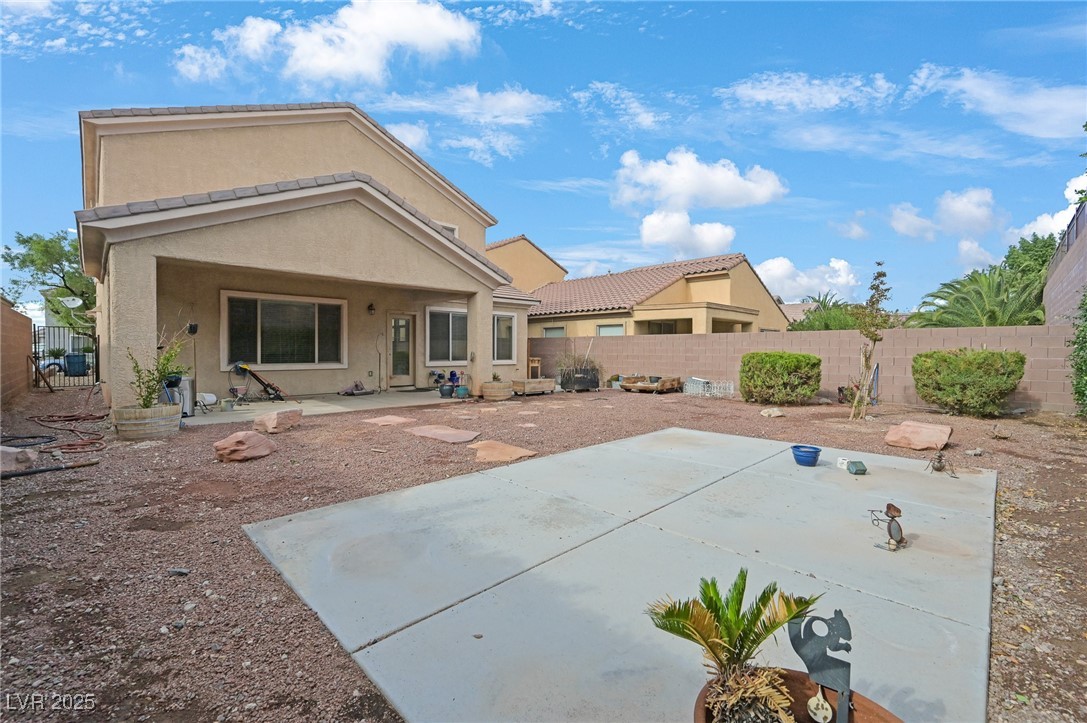 2289 Manosque Lane Henderson, NV 89044 - Photo 34 of 35 Rear view of property featuring a patio area, a fenced backyard, and stucco siding