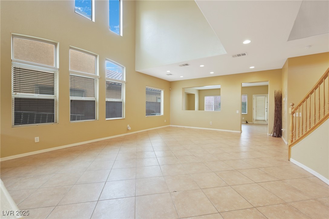 2289 Manosque Lane Henderson, NV 89044 - Photo 4 of 35 Spare room featuring stairs, recessed lighting, light tile patterned floors, and a high ceiling