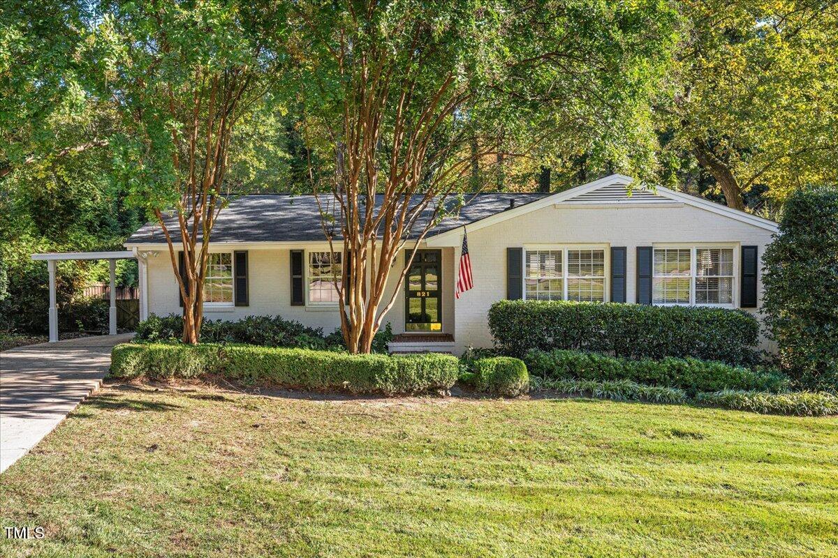 821 Macon Place Raleigh, NC 27609 - Photo 1 of 32 a front view of a house with a yard