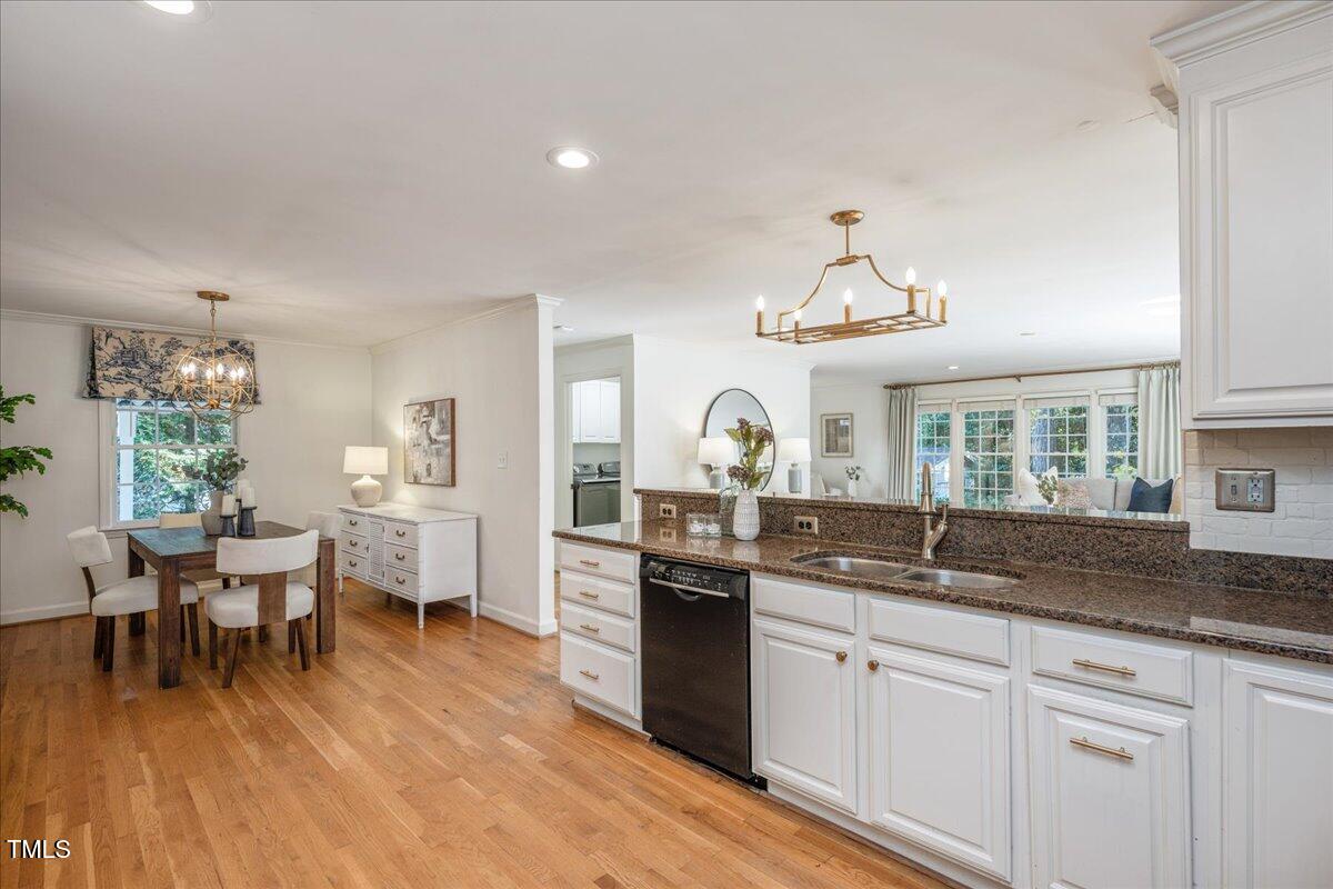 821 Macon Place Raleigh, NC 27609 - Photo 16 of 32 a kitchen with a sink and cabinets