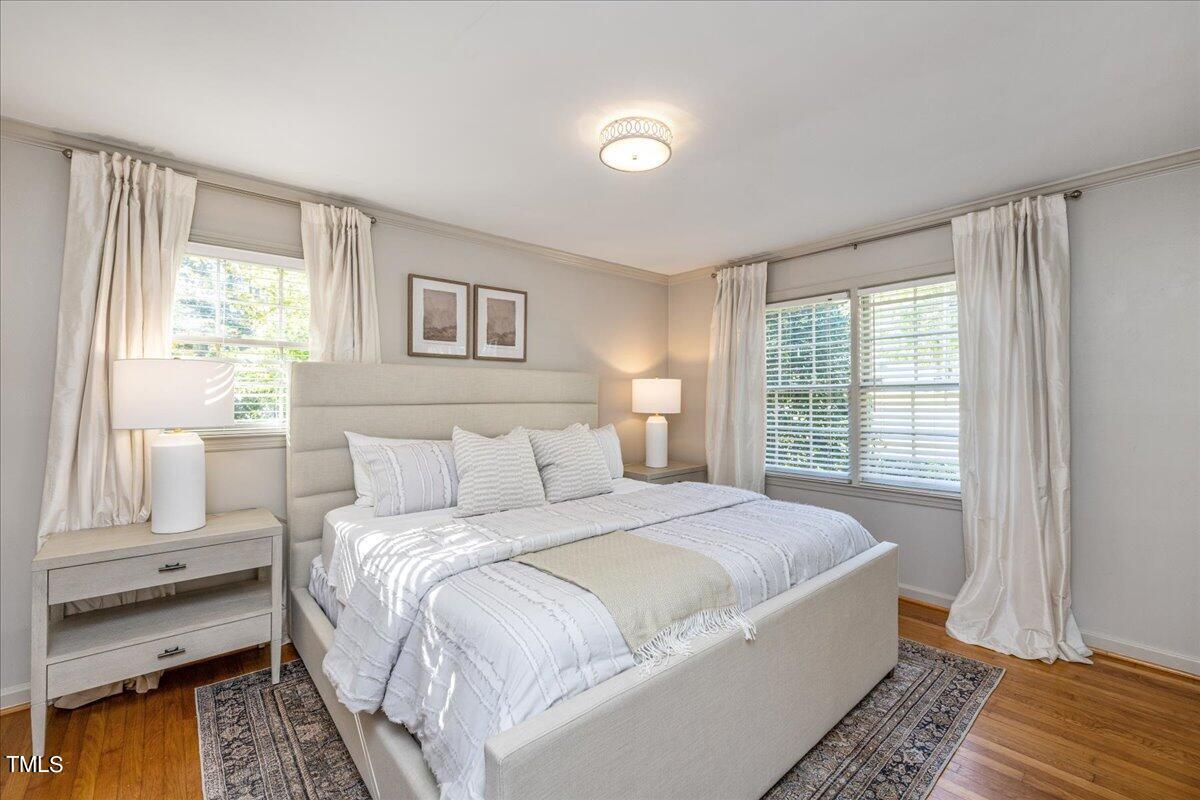 821 Macon Place Raleigh, NC 27609 - Photo 20 of 32 a bedroom with a bed and a window