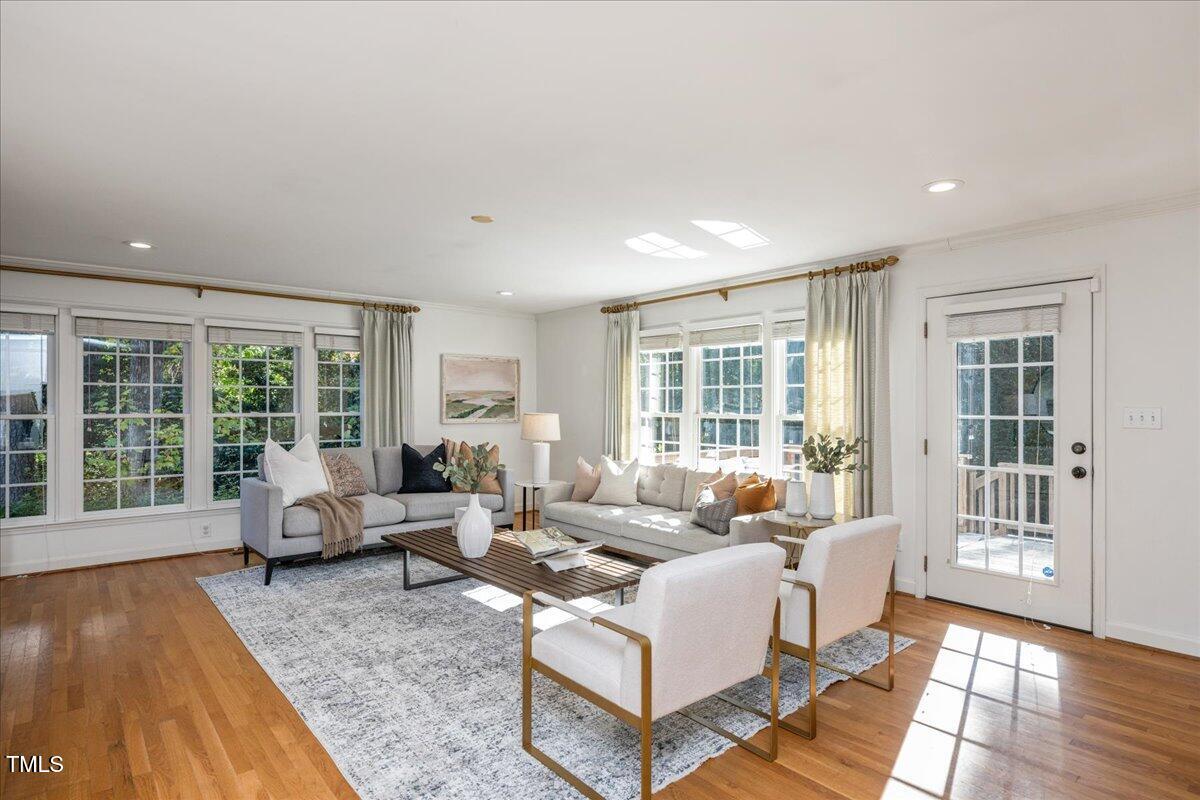 821 Macon Place Raleigh, NC 27609 - Photo 2 of 32 a living room with furniture and floor to ceiling windows