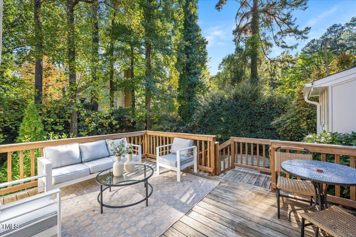 821 Macon Place Raleigh, NC 27609 - Photo 4 of 32 a view of a patio with couches table and chairs and wooden floor