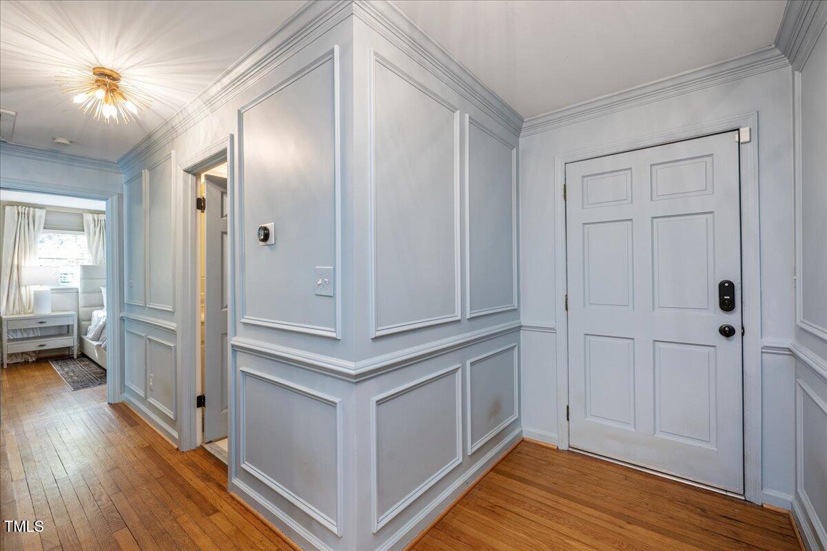 821 Macon Place Raleigh, NC 27609 - Photo 5 of 32 a view of a hallway with wooden floor and a bathroom