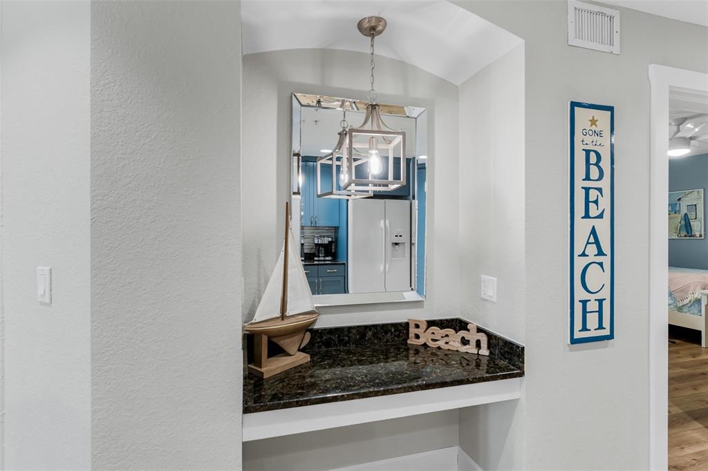399 2nd Street, Unit 215 Indian Rocks Beach, FL 33785 - Photo 14 of 51 a bathroom with a granite countertop sink and cabinets