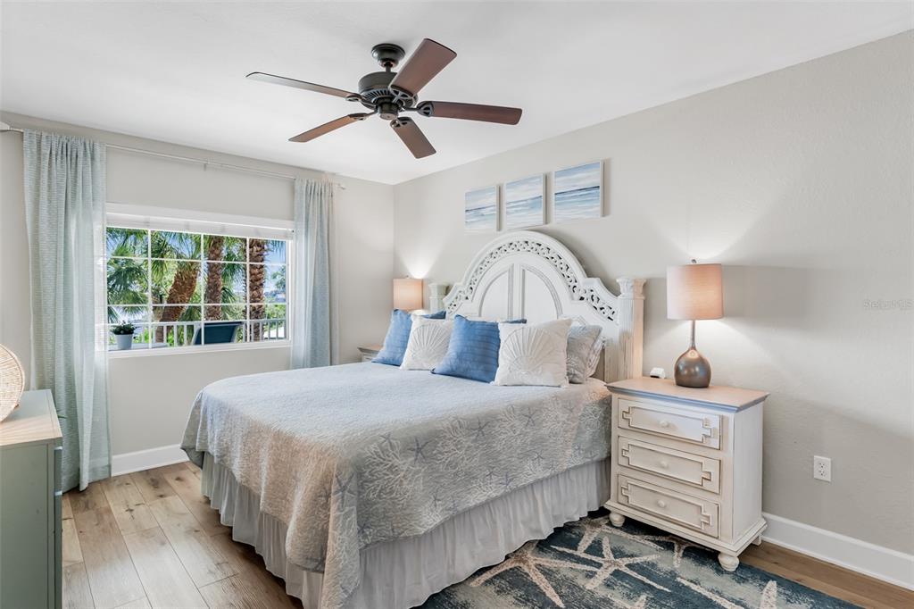 399 2nd Street, Unit 215 Indian Rocks Beach, FL 33785 - Photo 16 of 51 a bedroom with a bed and a chandelier