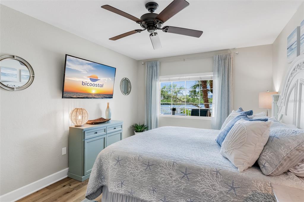399 2nd Street, Unit 215 Indian Rocks Beach, FL 33785 - Photo 18 of 51 a bedroom with a bed and a flat screen tv