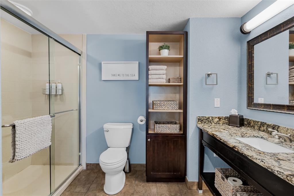 399 2nd Street, Unit 215 Indian Rocks Beach, FL 33785 - Photo 20 of 51 a bathroom with a granite countertop toilet sink and mirror