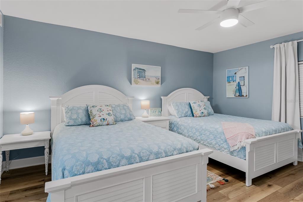 399 2nd Street, Unit 215 Indian Rocks Beach, FL 33785 - Photo 23 of 51 a bedroom with two beds and painting on the wall