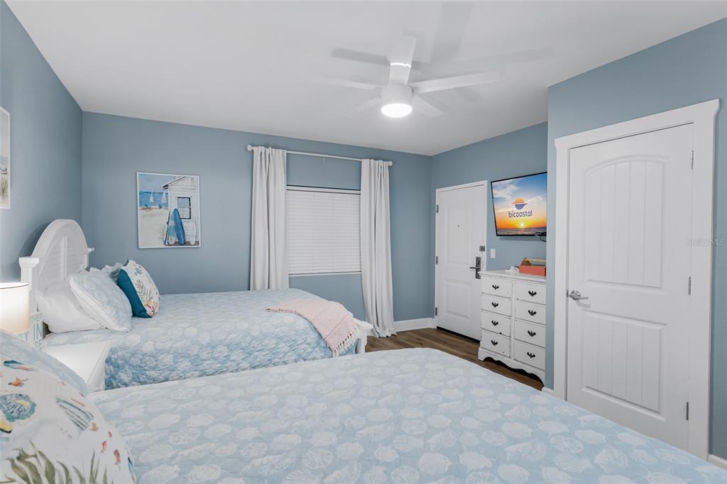 399 2nd Street, Unit 215 Indian Rocks Beach, FL 33785 - Photo 24 of 51 a bedroom with a bed and cabinets