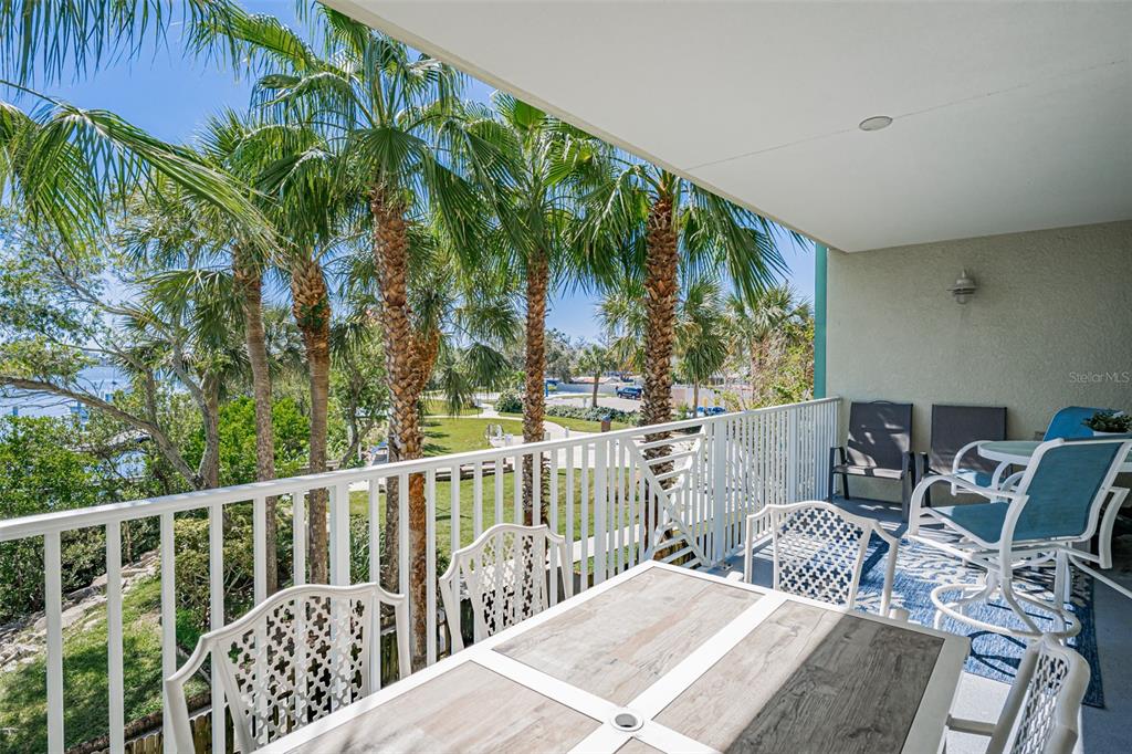 399 2nd Street, Unit 215 Indian Rocks Beach, FL 33785 - Photo 29 of 51 a view of balcony with wooden floor and outdoor seating