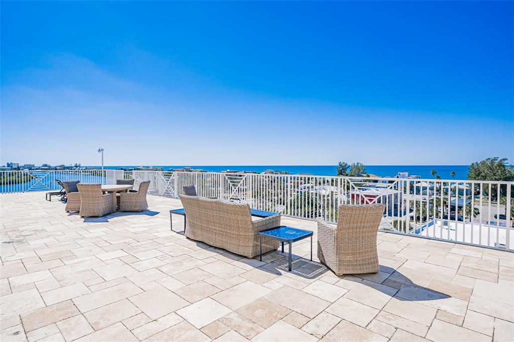399 2nd Street, Unit 215 Indian Rocks Beach, FL 33785 - Photo 34 of 51 a roof deck with a couches and city view
