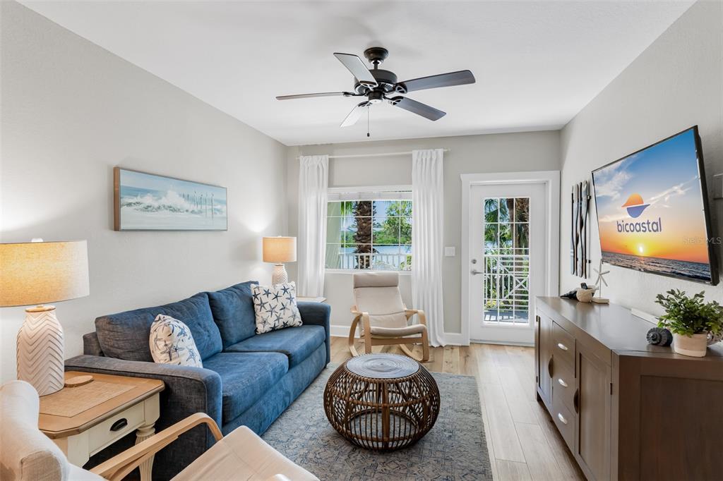 399 2nd Street, Unit 215 Indian Rocks Beach, FL 33785 - Photo 4 of 51 a living room with furniture and a large window